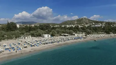 an aerial view of a beach with umbrellas and the water at Amazing Garden House in Athens