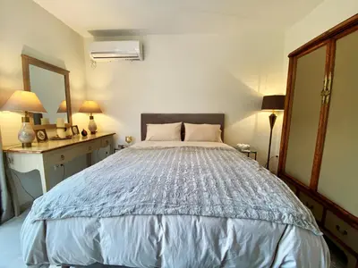 a bedroom with a large bed and a mirror at Amazing Garden House in Athens
