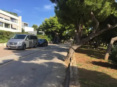 a van parked on the side of a street at Cute 1bd Apartment at Vouliagmeni in Athens