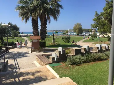 a park with a bunch of graves and a palm tree at Cute 1bd Apartment at Vouliagmeni in Athens
