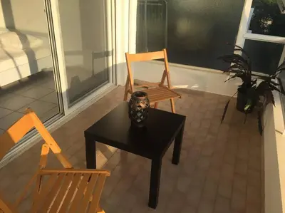 a table with a vase on it next to two chairs at Cute 1bd Apartment at Vouliagmeni in Athens