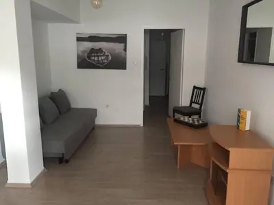 a living room with a couch and a table at Cute 1bd Apartment at Vouliagmeni in Athens