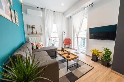 a living room with a couch and a table at Calypso Apartment in Athens
