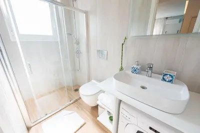 a bathroom with a toilet and a sink and a shower at Calypso Apartment in Athens