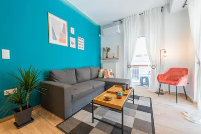 a living room with a couch and a table at Calypso Apartment in Athens