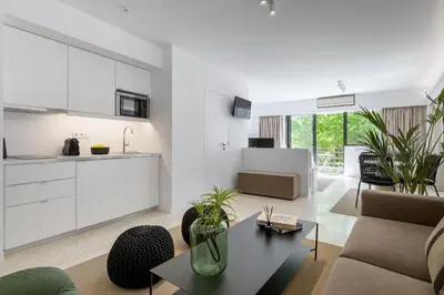 a living room with a couch and a table at Momo Suites, Acropolis by Aura Homes in Athens