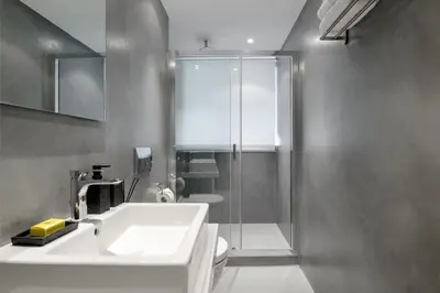 a bathroom with a sink and a shower at Momo Suites, Acropolis by Aura Homes in Athens