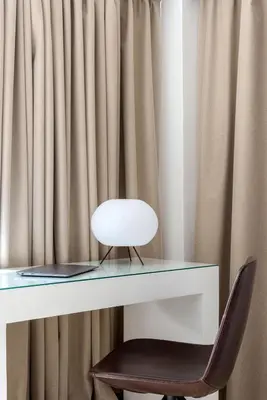 a white chair sitting in front of a desk at Momo Suites, Acropolis by Aura Homes in Athens