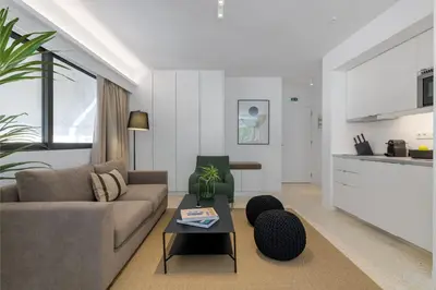 a living room with a couch and a table at Momo Suites, Acropolis by Aura Homes in Athens