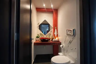 a bathroom with a sink and a toilet and a mirror at 5-Star feel - Luxury penthouse for 4 with huge balcony & view ,8 min from Athens airport in Koropíon
