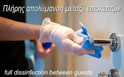a person in gloves washing a faucet with a rag at METROPOLITAN MACVIEW-4 ΔΙΑΜΕΡΙΣΜΑ in Piraeus
