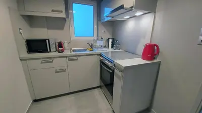 a small kitchen with a sink and a refrigerator at METROPOLITAN MACVIEW-4 ΔΙΑΜΕΡΙΣΜΑ in Piraeus