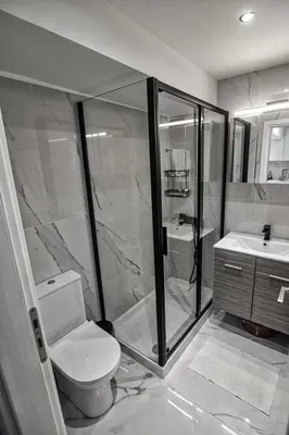 a bathroom with a shower and a toilet and a sink at LIVAS Athens Voula garden bungalow in Athens