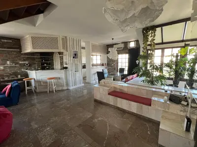 a living room with a couch and a table at LIVAS Athens Voula garden bungalow in Athens