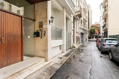 an empty street with cars parked on the sides of buildings at Downtown Cute Apt in the Heart of Plaka (+Netflix) in Athens