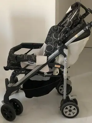 a black and white stroller sitting on the floor at Downtown Cute Apt in the Heart of Plaka (+Netflix) in Athens
