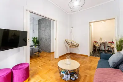 a living room with a couch and a table at Downtown Cute Apt in the Heart of Plaka (+Netflix) in Athens
