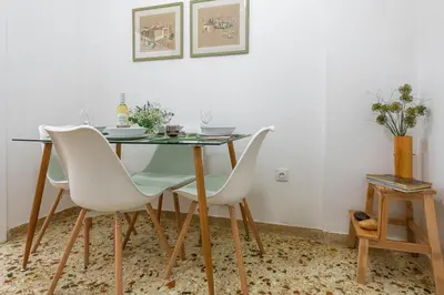 a dining room with a table and white chairs at Nadia’s Boutique Apartment, Athens in Athens
