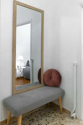 a mirror sitting on a bench in a room at Nadia’s Boutique Apartment, Athens in Athens
