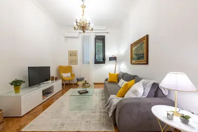 a living room with a couch and a tv at Nadia’s Boutique Apartment, Athens in Athens