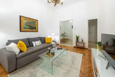 a living room with a couch and a glass table at Nadia’s Boutique Apartment, Athens in Athens