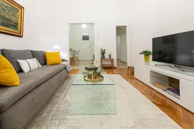 a living room with a couch and a tv at Nadia’s Boutique Apartment, Athens in Athens