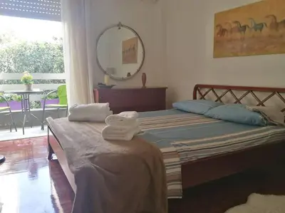a bedroom with a bed with towels on it at Maria's Cozy apartment in Palaio Faliro in Athens