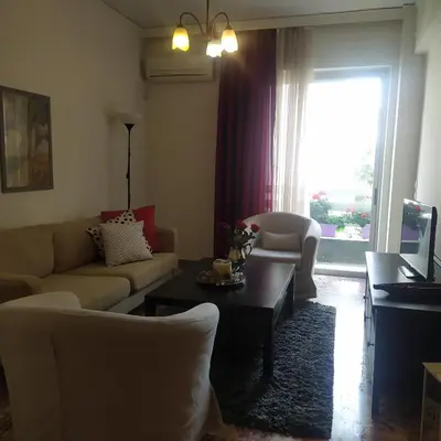 a living room with a couch and a table at Maria's Cozy apartment in Palaio Faliro in Athens
