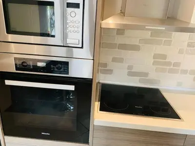 a microwave and an oven in a kitchen at Astra House in Porto Rafti