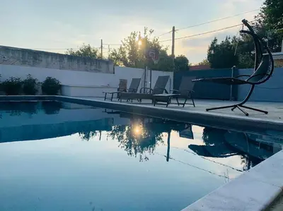 a swimming pool with two chairs sitting next to it at Astra House in Porto Rafti