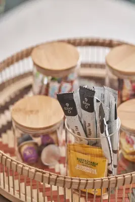 a basket with jars of food on a table at Chic n Bright 3Bd Apt with Hilton View in Athens