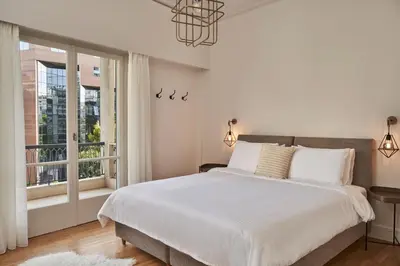 a bedroom with a large bed and a window at Chic n Bright 3Bd Apt with Hilton View in Athens