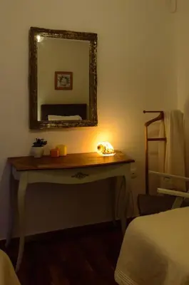 a bedroom with a table with a mirror and a bed at Cozy and comfortable apartment in Athens Center in Athens