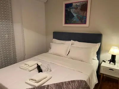 a bed with two towels and two glasses on it at Cozy and comfortable apartment in Athens Center in Athens
