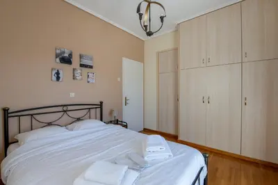a bedroom with a bed with towels on it at Alimos Marina Sunnyhub in Athens