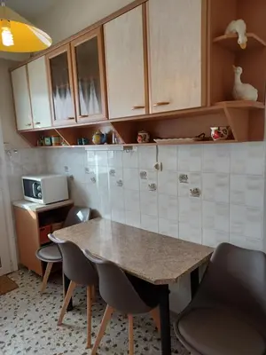 a kitchen with a table and chairs and a microwave at Alimos Marina Sunnyhub in Athens