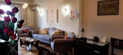 a living room with a couch and a table at Alimos Marina Sunnyhub in Athens