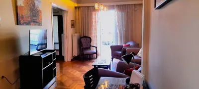 a living room with a tv and a living room with a couch and chairs at Alimos Marina Sunnyhub in Athens
