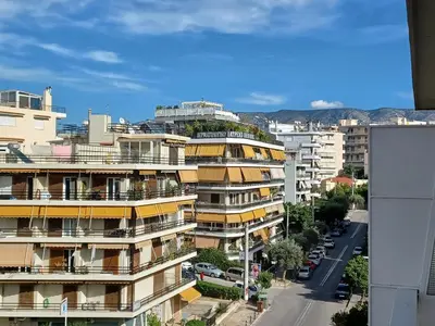 an apartment building with a green dome on top of it at Alimos Marina Sunnyhub in Athens
