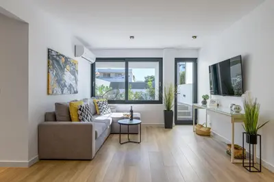 a living room with a couch and a table at Pool Voula Apartment close to Kavouri Beach by Cielo Homes in Athens