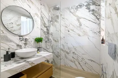 a bathroom with a sink and a mirror at Pool Voula Apartment close to Kavouri Beach by Cielo Homes in Athens