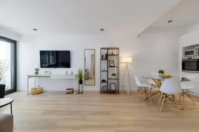 a living room with white walls and a table and chairs at Pool Voula Apartment close to Kavouri Beach by Cielo Homes in Athens