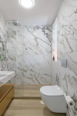 a bathroom with a white toilet and a shower at Pool Voula Apartment close to Kavouri Beach by Cielo Homes in Athens