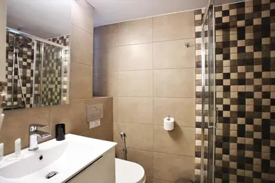 a bathroom with a sink and a toilet and a shower at GK Aria by GK Properties in Athens
