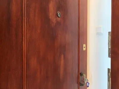 a wooden door with a handle in a room at GK Aria by GK Properties in Athens
