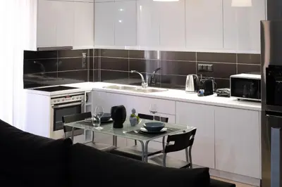 a kitchen with a glass table and a sink at Chalandri Sweet House in Athens