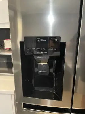a silver refrigerator with a coffee maker in it at Chalandri Sweet House in Athens