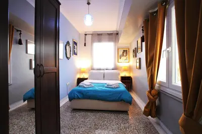 a small bedroom with a bed and a window at Vintage Apartment in Athens