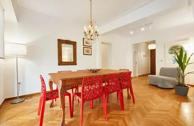 a dining room with a table and red chairs at Chloe Boutique Apartments Nikis in Athens