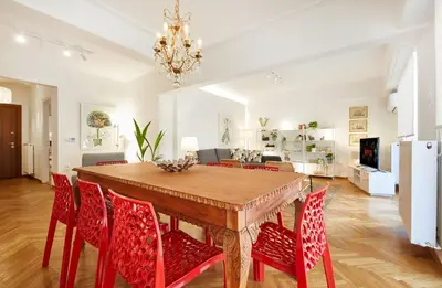 a dining room with a table and red chairs at Chloe Boutique Apartments Nikis in Athens